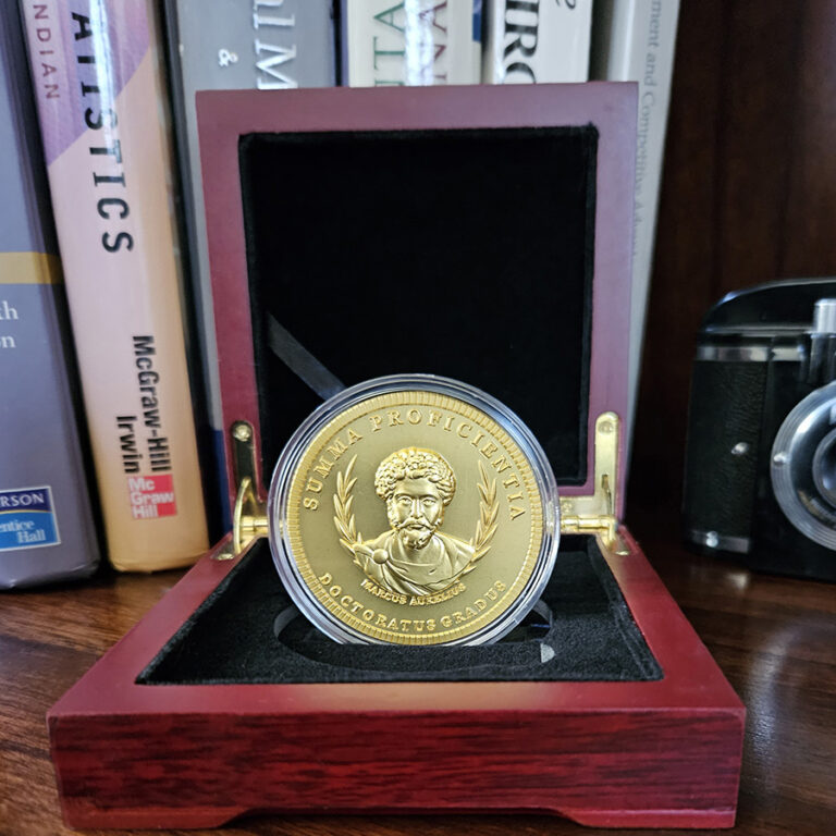 Doctorum's PhD Coin featuring Marcus Aurelius This is indeed a remarkable tribute and an exceptional gift for the PhD in your life. Whether celebrating a new PhD program graduate or honoring the seasoned Doctor, this unique creation is sure to make a lasting impression.